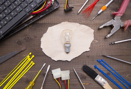 Lamp, tools and broken computerの写真素材