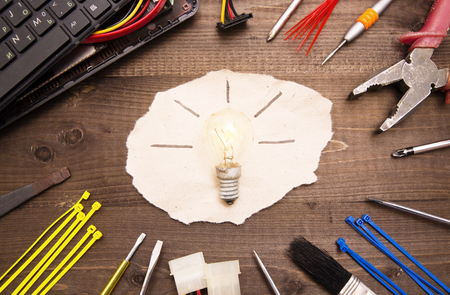 Lamp, tools and broken computerの写真素材