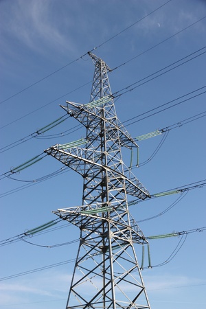 Electric power lines against blue sky.の写真素材