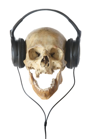 Human skull in headphones isolated on a white background.の写真素材