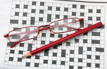Pencil and glasses on the newspaper with a crossword.の写真素材