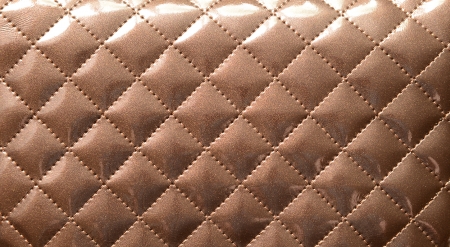 Background, pattern. Brown leather upholstery close up.の写真素材