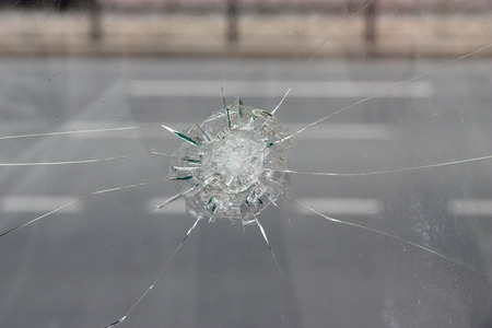 Crack in glass. Broken glass close up.の写真素材
