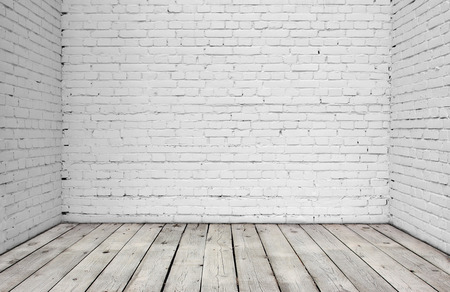 Old white brick wall and wood floor.の写真素材