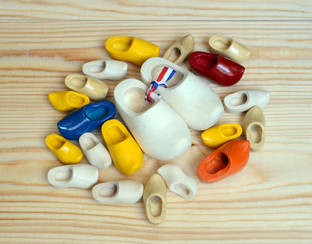 Colorful dutch wooden shoes on wooden panels.