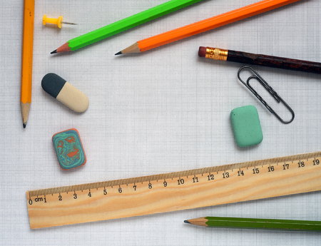 Pencils and wooden ruler on a graph paperの写真素材
