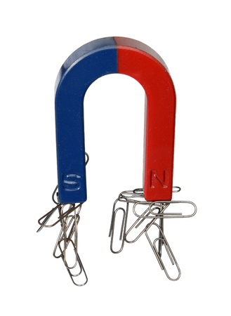 Magnet and paper clips isolated on a white background.の写真素材