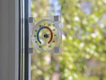 Thermometer on the window. Summer backgroundの写真素材