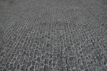 Abstract background. Old cobblestone pavement close-up.の写真素材
