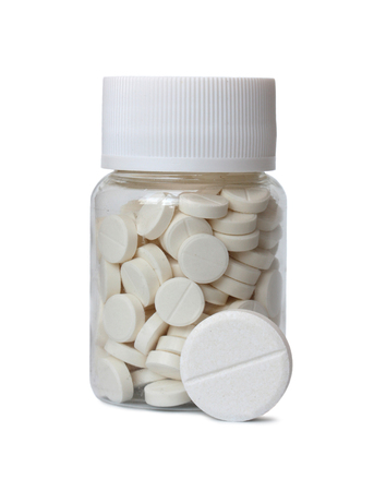 Bottle with pills isolated on a white background.の写真素材