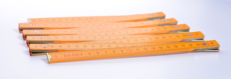 Yellow carpenter's ruler on a white background