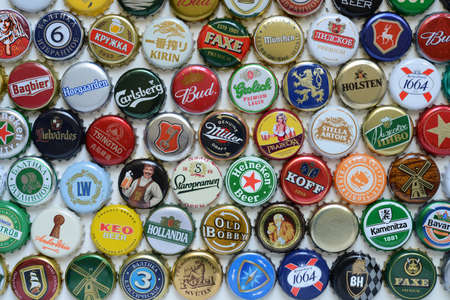 St. Petersburg, Russia - October 10, 2020: Set of beer caps on a white background. A mix of various...