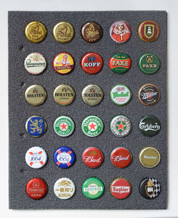 St. Petersburg, Russia - October 10, 2020: Set of beer caps on a black background.