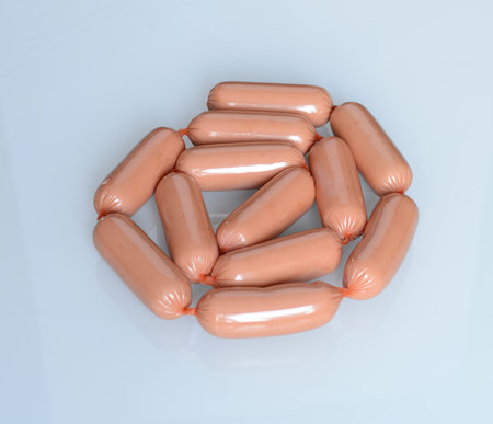 Bunch of raw sausages on a white background. Pile of sausagesの写真素材