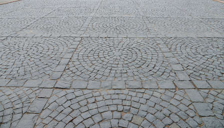 Abstract background. Old cobblestone pavement close-up.の写真素材