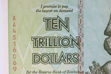 The text is ten trillion dollars closeup on a Zimbabwe banknote.