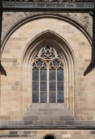 A Gothic style window on the wall of an old temple.