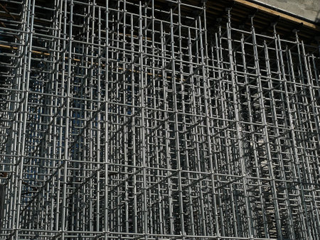 Background. Facade of a building under construction with scaffolding