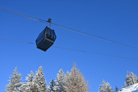 Cable car cabin against blue sky. Gondola lift in the mountainsの写真素材