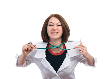 Woman doctor get into a fuss and angry. On display is strangling itself stethoscope. The girl is completely isolated on a white background.の写真素材