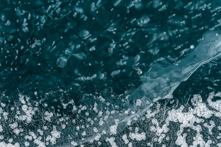 Beautiful pure ice with cracks on the Lake Baikal. Unique, wonderful, clean, cool ice of the largest and cleanest lake in the world.の写真素材