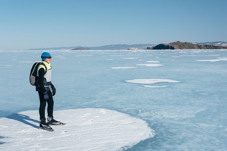Tourists travel to Norway hiking ice skating on the frozen lake. Special long skate for long distances. Mounting under the ski boots. Location of Lake Baikal action. The Russian called Bayes or Loft.の写真素材