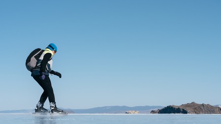 Tourists travel to Norway hiking ice skating on the frozen lake. Special long skate for long distances. Mounting under the ski boots. Location of Lake Baikal action. The Russian called Bayes or Loft.の写真素材