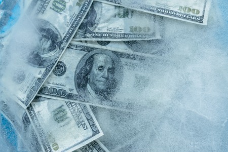 100 dollars frozen melt. Banknotes frozen in ice.の写真素材