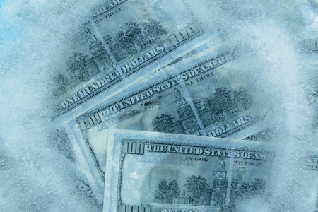 100 dollars frozen melt. Banknotes frozen in ice.の写真素材