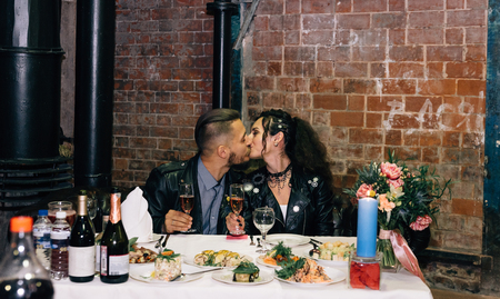 Wedding in the style of rock. Rocker or Biker wedding. Guys with stylish leather jackets. Its a rocknroll baby! Sweet couple kisses.の写真素材