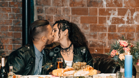 Wedding in the style of rock. Rocker or Biker wedding. Guys with stylish leather jackets. Its a rocknroll baby. Sweet couple kisses.の写真素材