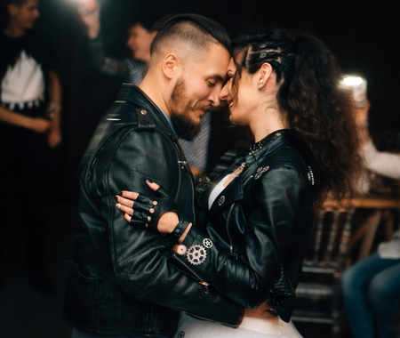 Wedding in the style of rock. Rocker or Biker wedding. Guys with stylish leather jackets. Its a rocknroll baby. A wedding dance.の写真素材