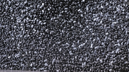 Plastic black gray granulated crumb. Manufacture of plastic water pipes of the factory. Process of...