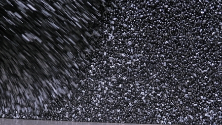 Plastic black gray granulated crumb. Manufacture of plastic water pipes of the factory. Process of making plastic tubes on the machine tool with the use of water and air pressure.の写真素材