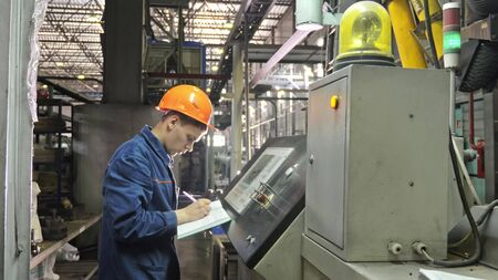RUSSIA, ANGARSK - JUNE 8, 2018: Operator monitors control panel of production line. Manufacture of...
