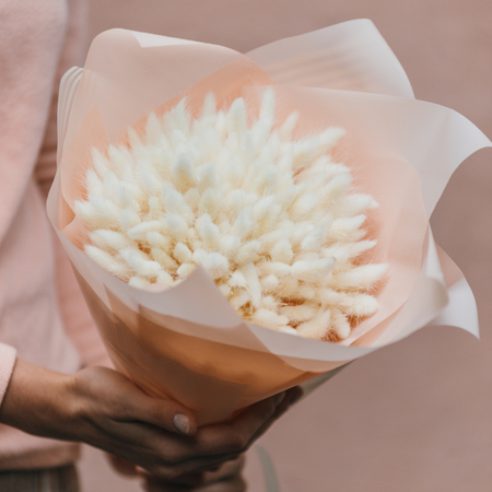 Colorful bouquet of different dried flowers deadwood flowers in the hands of a florist woman. Rustic flower background. Craft bouquet of flowers.の写真素材