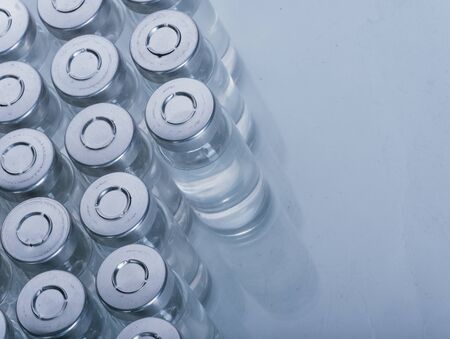 Glass medical ampoule vial for injection. Medicine is dry white drug penicillin powder or liquid...