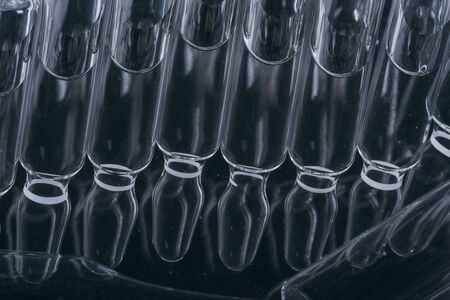 Glass medical ampoule vial for injection. Medicine is liquid sodium chloride with of aqueous...