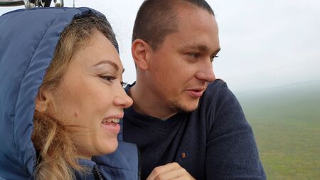 Adventure love couple on hot air balloon watermelon. Man and woman kiss hug love each other. Burner...