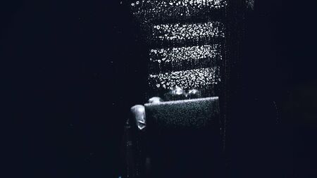 Internal view from inside of the glass a car while being car wash. Washing dishes with a sponge with...