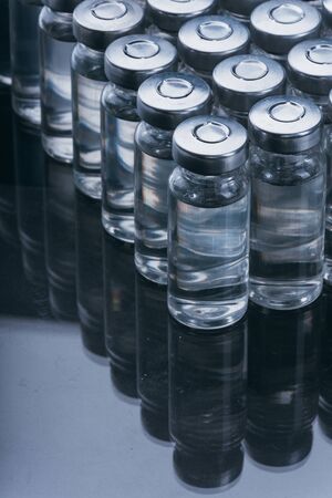 Glass medical ampoule vial for injection. Medicine is dry white drug penicillin powder or liquid with of aqueous solution in ampulla.の写真素材