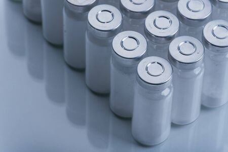 Glass medical ampoule vial for injection. Medicine is dry white drug penicillin powder or liquid with of aqueous solution in ampulla.の写真素材