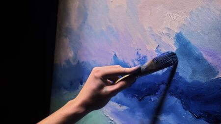 Artist copyist paint seascape with ship in ocean. Craftsman decorator draw as boat sail on blue sea...