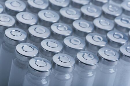 Glass medical ampoule vial for injection. Medicine is dry white drug penicillin powder or liquid with of aqueous solution in ampulla.の写真素材