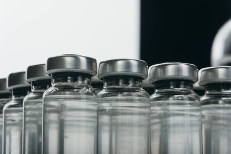 Glass medical ampoule vial for injection. Medicine is dry white drug penicillin powder or liquid...