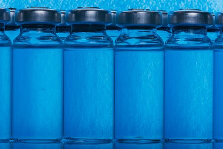 Glass medical ampoule vial for injection. Medicine is liquid sodium chloride with of aqueous solution in ampulla.の写真素材