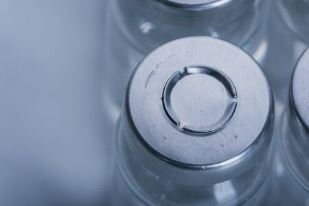 Glass medical ampoule vial for injection. Medicine is dry white drug penicillin powder or liquid...