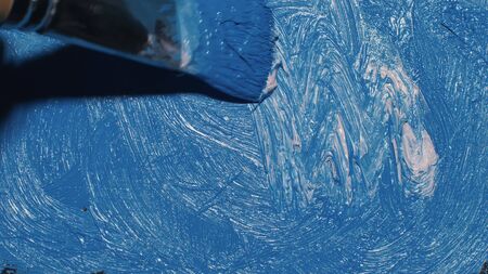 Artist copyist paint seascape with ship in ocean. Craftsman decorator draw as boat sail on blue sea with acrylic oil color. Draw finger, brush, knife palette. Indoor. Close up cinematic look.の写真素材