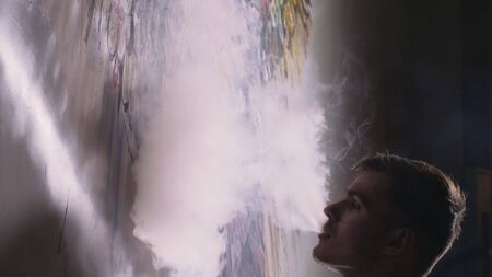 Artist designer draws an eagle on the wall. Craftsman decorator paints a picture with acrylic oil...