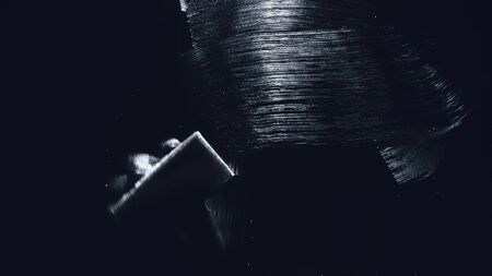 Internal view from inside of the glass a car while being car wash. Washing dishes with a sponge with dishwashing foam gel. Hand holds sponge with detergent or polishing liquid. Polish, or wash dish.の写真素材